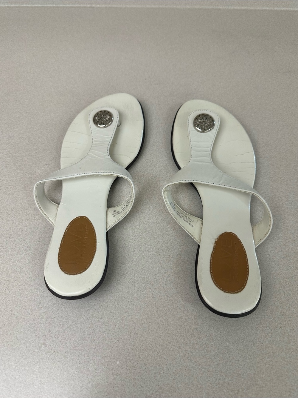 Women's White Leather Toe-Post Sandals with Decorative Medallion